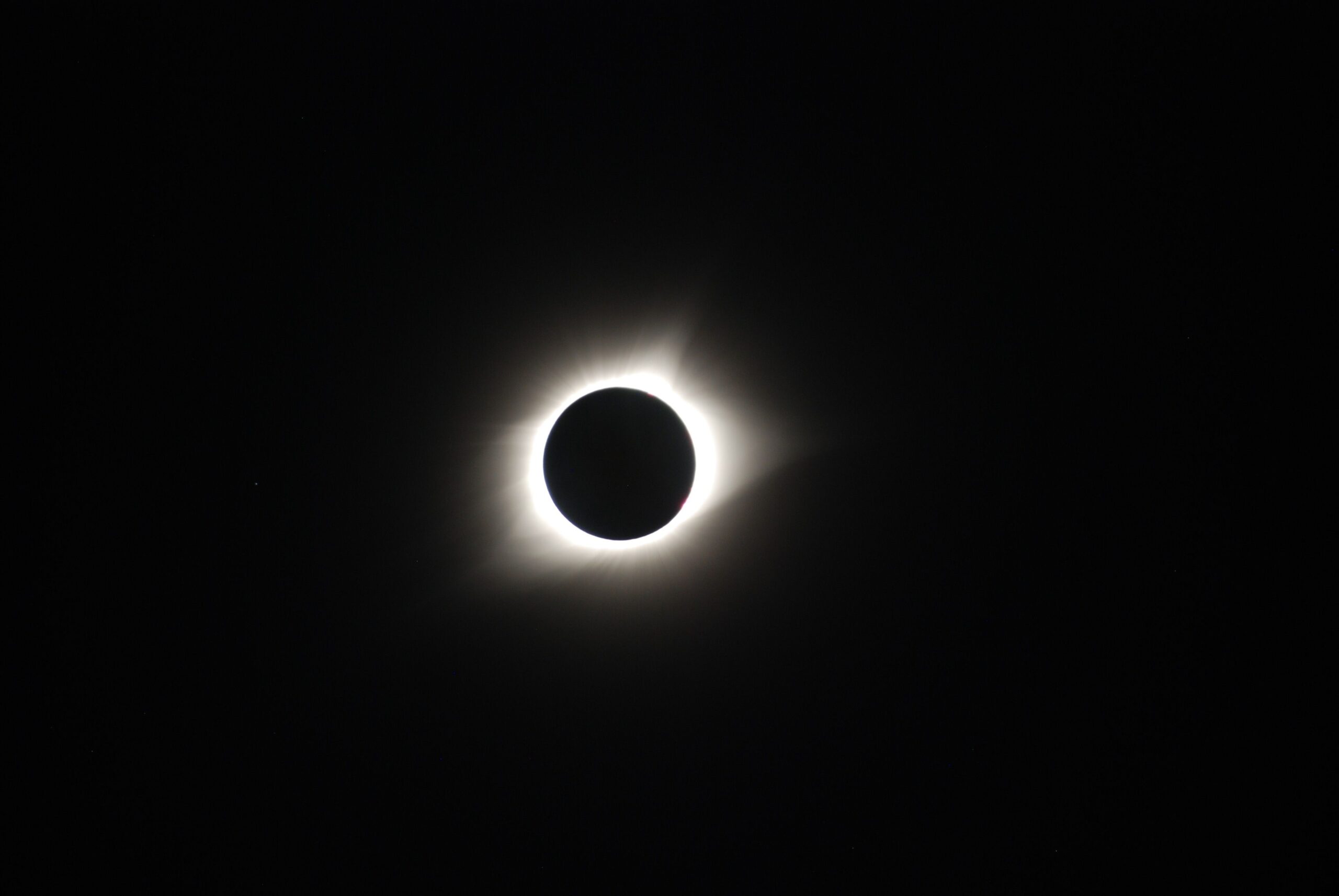 Captivating image of a total solar eclipse showcasing the sun's corona in the dark sky.